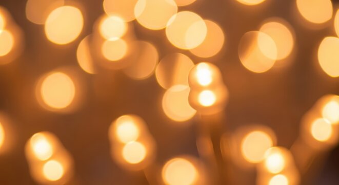 Warm golden orbs create an abstract background effect with soft focus and glowing light