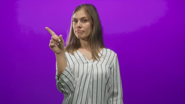 Young blonde woman hand on chin looking thoughtful with meditative gaze in purple studio; contemplation.
