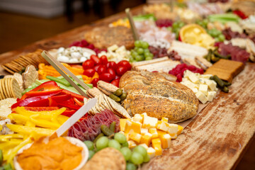 Large Charcuterie Board at an event with variety of finger foods	

