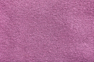Close-up shot of a purple ribbed textile, showcasing the vertical texture and soft material.
