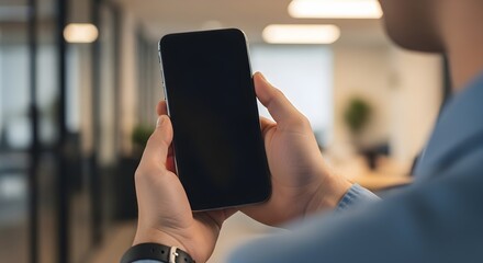 Man holding a smartphone in the office