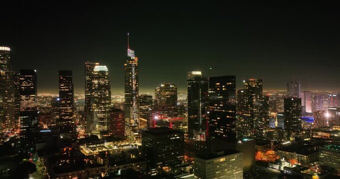 Scenic aerial view of skyscrapers in Los Angeles city at night. Illuminated buildings in Los Angeles skyline, Aerial drone shot, Los Angeles, California. Skyline towers in LA.
