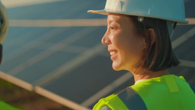 Experienced worker inspects solar panels at renewable energy site