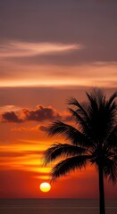 Obraz premium Vibrant tropical sunset silhouette features a solitary palm tree against fiery skies above ocean waters