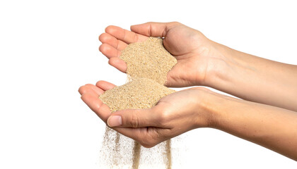 Two hands holding sand, with granules flowing out against a black background