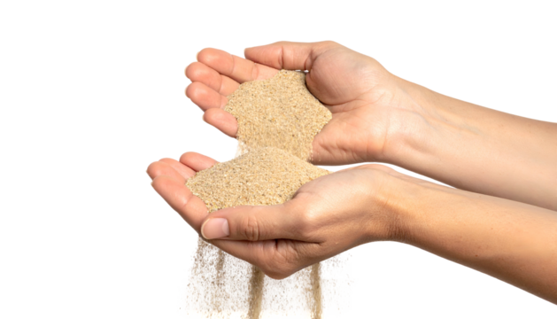 Two hands holding sand, with granules flowing out against a black background