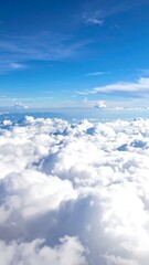 Aerial view of fluffy white clouds stretching to the horizon under a bright blue sky, evoking serenity and vastness