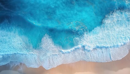 aerial view of turquoise ocean waves breaking onto a sandy beach with white foam, a serene and calming coastal scene