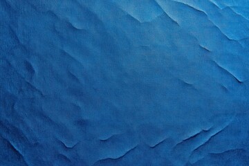 Fototapeta premium textured deep blue crumpled paper surface with soft folds torn edges subtle shadows and a calm serene mood