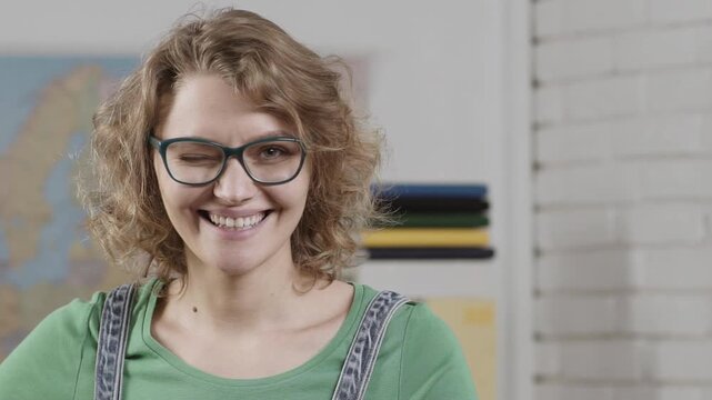 Students face. Portrait close up of female Student studying or teacher in shcool class. Portrait of creative young smiling female Student in glasses. Female teacher in glasses in the classroom.