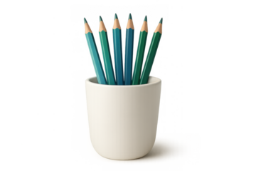 Color pencils in shades of green and blue arranged in a simple white ceramic holder, illustrating school supplies and creativity
