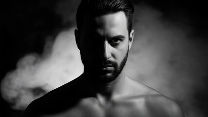 Black and white portrait of a serious bearded adult male with an intense gaze. Masculinity and confidence concept with dramatic lighting and smoke on a dark background - Powered by Adobe