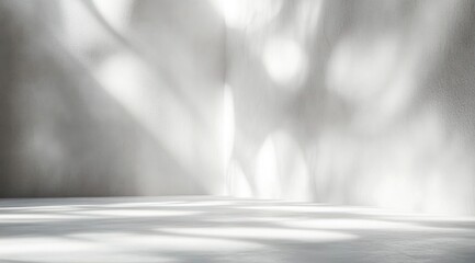 Empty minimalist white corner with textured walls and dappled sunlight casting soft leaflike shadows, serene mood