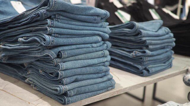 Denim stacks in a clothing store during daytime hours