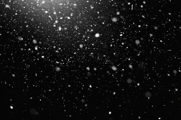Fototapeta premium Gentle nighttime snowfall of delicate snowflakes and soft glowing bokeh against a dark sky, peaceful and magical
