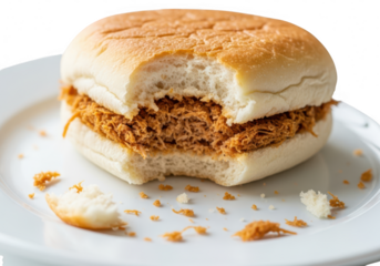 Closeup of a partially eaten shredded pork bun on a white plate isolated on transparent background the bun has a bite taken out of it