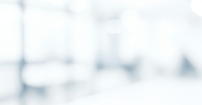 Bright white and light blue abstract background with soft focus shapes, forming a calm luminous ambience with gentle glowing highlights and smooth visual gradients across the scene.