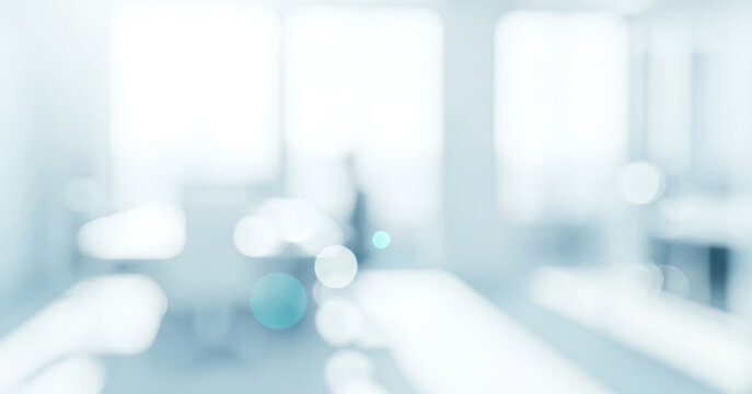 Bright abstract office interior background with soft blue and white bokeh lights, creating a smooth glowing atmosphere ideal for modern workspace layouts and clean professional presentation visuals.