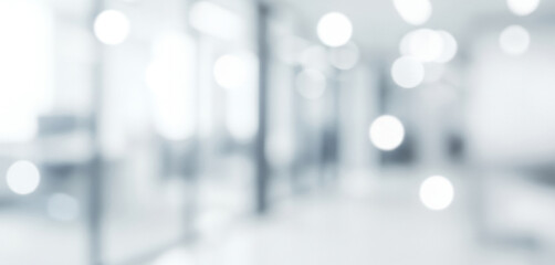 Abstract bright white and gray background with soft circular bokeh lights, forming a serene glowing ambience with subtle luminous highlights that evoke a clean, elegant, and airy visual impression.