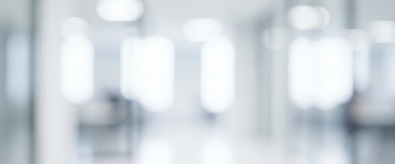 Bright abstract background of a blurry indoor hallway with white light sources, forming a soft glowing ambience that feels clean and modern, with luminous highlights guiding the visual flow.
