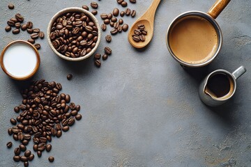top view of roasted coffee beans scattered around a bowl, wooden spoon, small milk jar, saucepan of brewed coffee and a creamer on a textured gray surface, warm and cozy mood