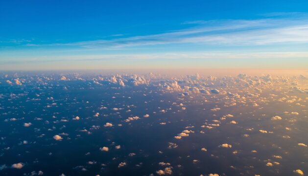 Wide aerial view of blue sky and horizon with tiny fluffy clouds during sunset or sunrise, beautiful atmospheric background - Powered by Adobe