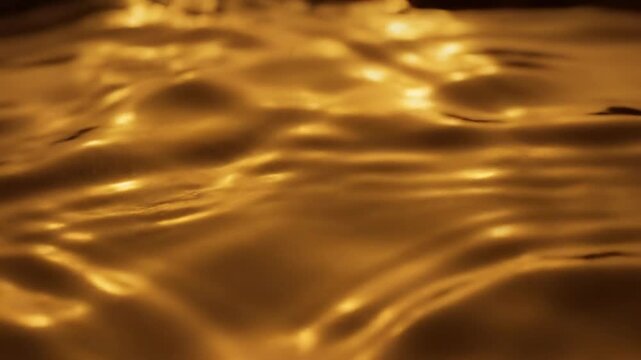 Intricate surface tension ripples moving across a reflective oily liquid base illuminated by intense subsurface golden light calm, energy, kinetic