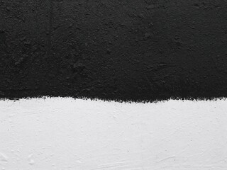 Abstract vertical texture background split into black asphalt and white painted concrete. High contrast surface.