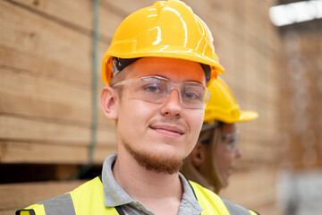 Wood factory worker man having injure at work. Man worker feeling pain in his leg from accident while working in warehouse.. Safety, Industry, Healthcare, Insurance Concept.