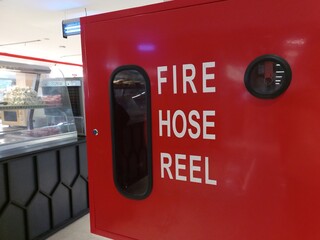 A fire extinguisher box containing a network of hoses and water pipes as a safety standard in buildings