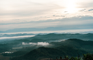 Beautiful Landscape of mountain layer in morning sun ray and winter fog at Doi Hua Mae Kham, Mae Salong Nai, Chiangrai, Thailand