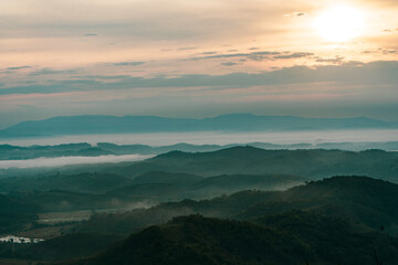 Beautiful Landscape of mountain layer in morning sun ray and winter fog at Doi Hua Mae Kham, Mae Salong Nai, Chiangrai, Thailand