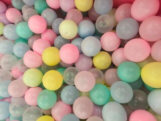 Close up of Pastel colored Plastic Balls in a Vibrant Ball Pit