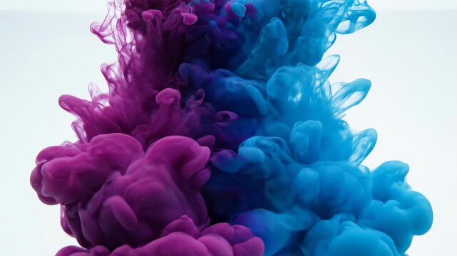 Macro slow motion view of deep magenta and cyan colored inks expanding and swirling in clear water creating beautiful diffusion meditative, water, transition