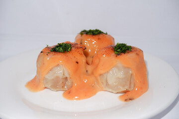 Dimsu with Japanese Mentai Sauce on white plate. Isolated on white background