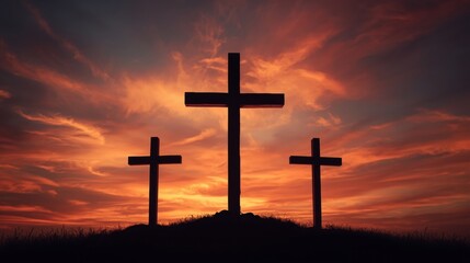 Three crosses silhouetted against a dramatic fiery sunset sky