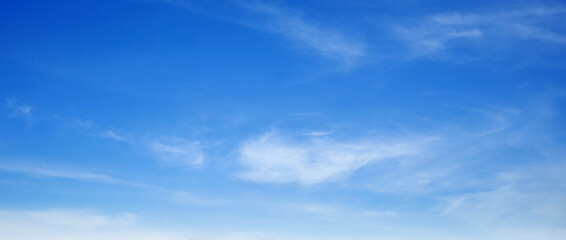 The sky is bright blue with cotton-like clouds floating above it.