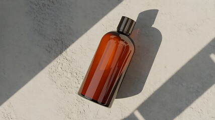 Amber glass bottle with striped cap casting a shadow on a textured surface