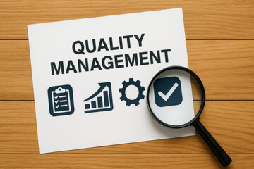 Quality management paper with icons illustrating process control and compliance concept. magnifying glass on wooden background symbolizes meticulous inspection for business assurance