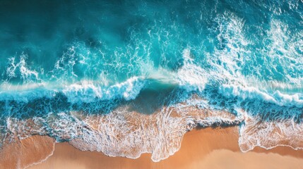 Obraz premium Crystal clear waters roll onto a golden sandy beach, creating beautiful waves under the bright sun. The tranquility of the scene invites relaxation and enjoyment.