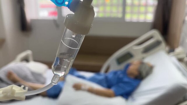 Hospital Bed and IV drip: Close-up of an intravenous drip against the backdrop of a hospital bed and a patient, evoking a sense of medical care and treatment.