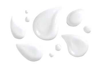 Isolated close-up of creamy, shiny, white droplets of various sizes against a black background