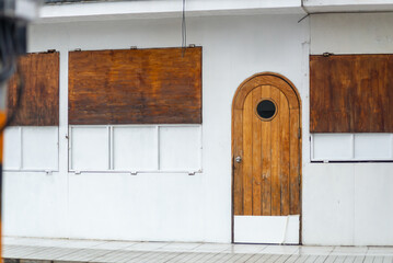Wooden Door on White Wall with Shutters