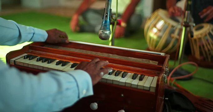 Cinematic Shot of Harmonium Playing During Devotional Program in Mandir