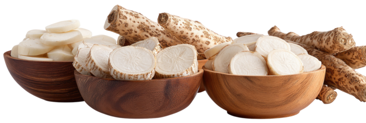 Raw yam pieces, some sliced, presented in wooden bowls alongside whole roots