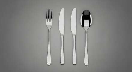 Modern metallic cutlery set with fork knives and spoon on a gray background