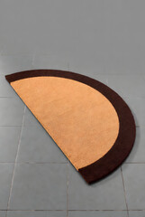 Semi-Circle Coir Doormat with Brown Border on Gray Floor (3D Render)