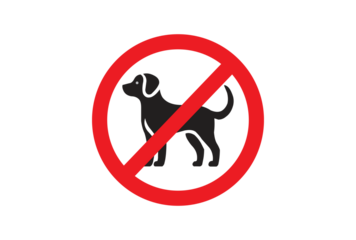No dogs allowed sign on a wall. Image depicts a prohibition sign