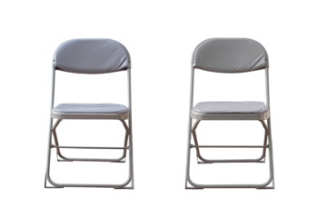Two grey metal folding chairs face front on a dark background