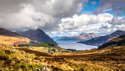 Majestic view of a wide, calm lake surrounded by brown, hilly terrain under a cloudy sky